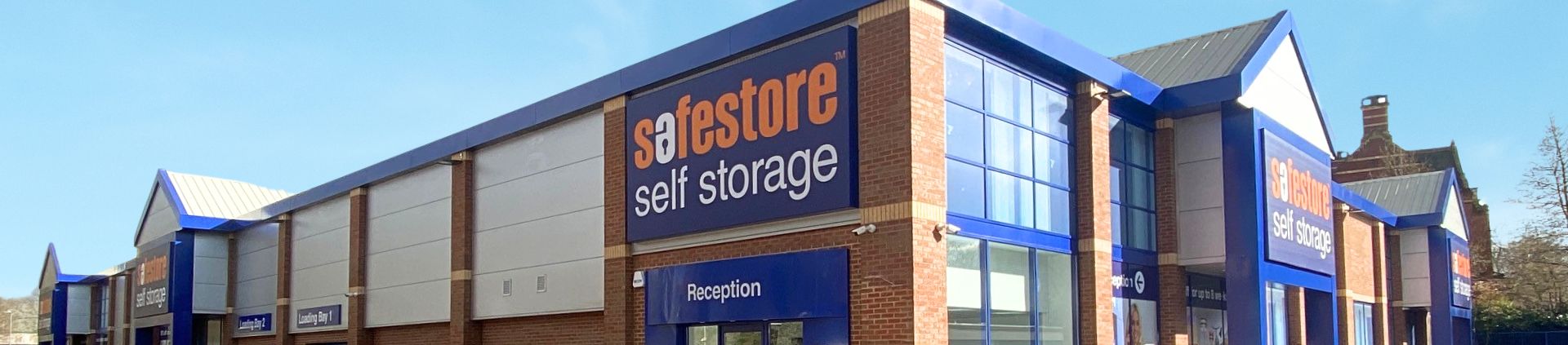Safestore storage corridor with storage units and trolley carrying boxes