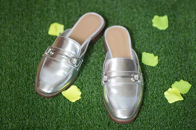 Silver mules on astro turf