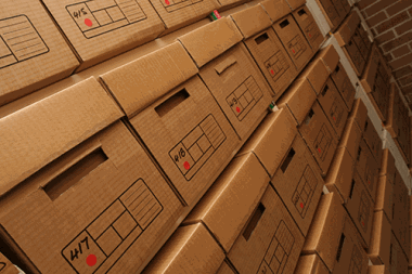 Close-up of archive boxes neatly stacked on racking inside a secure storage space