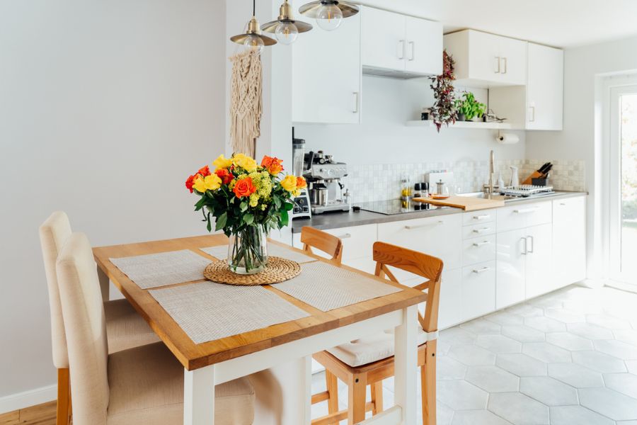 Bright, clutter-free kitchen diner with fresh flowers on the table, styled and ready for a home sale viewing