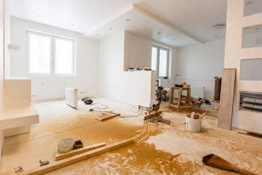 Interior of a house mid-renovation with tools, building materials, and unfinished walls