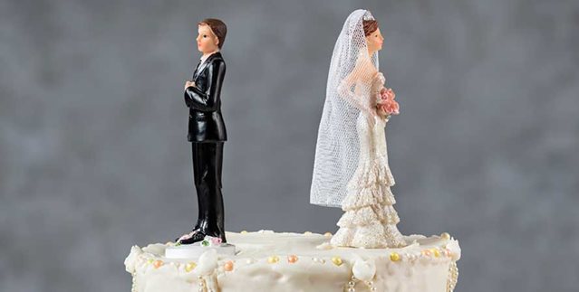 A wedding cake topper featuring a separated bride and groom, symbolising the challenges of relationship changes.