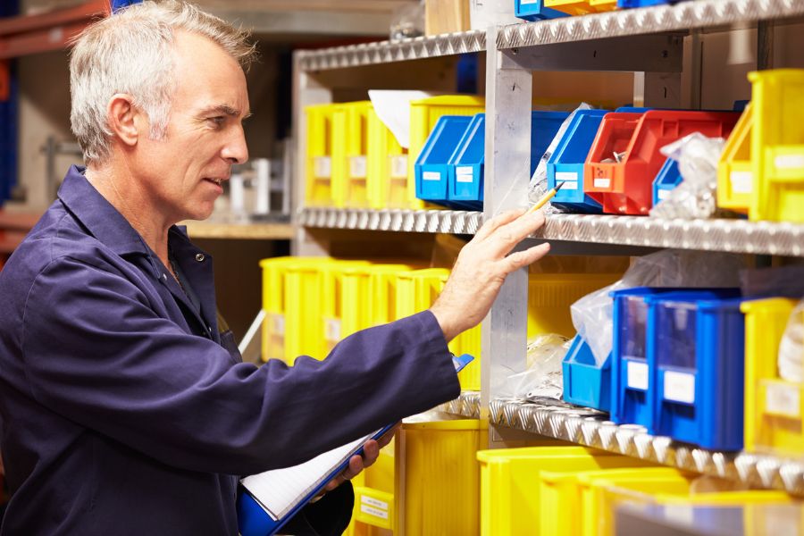 Man in blue overalls fulfilling customer orders inside a Safestore business storage unit