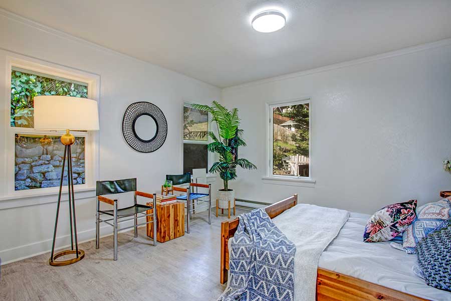 Stylish, inviting bedroom staged for a holiday let, featuring neatly made bed and tasteful decor.