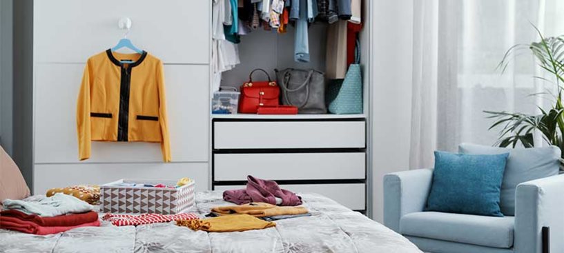 A cluttered bedroom being decluttered and organised with Safestore's storage solutions