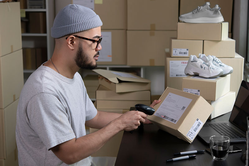 Small business owner packaging products for dispatch, representing online retailers using storage space